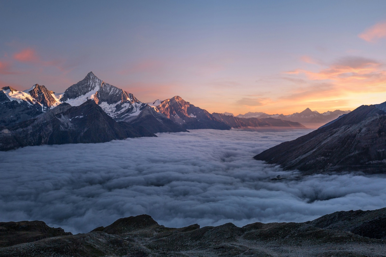 Mountain cabin overlooking valley at sunrise — illustrating the philosophy that every night has its true market value